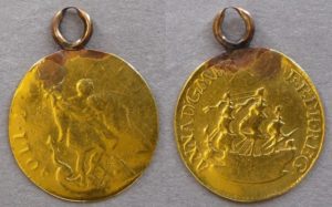 Queen Anne gold touch piece. Presented by Queen Ann at the ceremony of the Royal Touch and later given to Prince Albert (later King George VI) as a christening present, February 1896, with documents and envelope by Duchess of York (later Queen Mary). Loop mount attached.